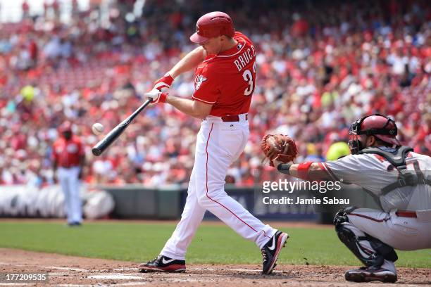 Jay Bruce of the Cincinnati Reds hits a double in the second inning against the Arizona Diamondbacks at Great American Ball Park on August 22, 2013...