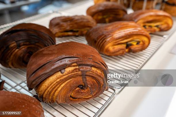 cinnamon buns on a tray - french culture stock pictures, royalty-free photos & images