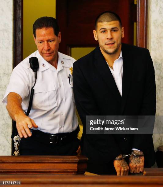 Aaron Hernandez is escorted into the courtroom of the Attleboro District Court for his hearing on August 22, 2013 in North Attleboro, Massachusetts....