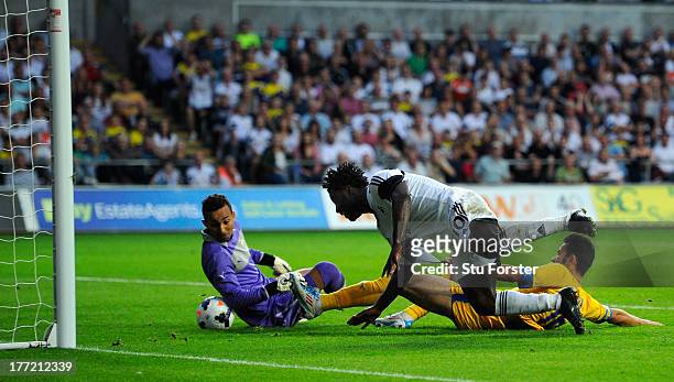 Swansea player Wilfried Bony stoops to head in the fourth swansea goal during the UEFA Europa League play-off first leg between Swansea City and FC...