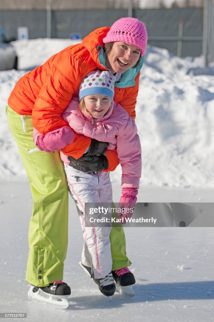 Mother and daughter ice skating