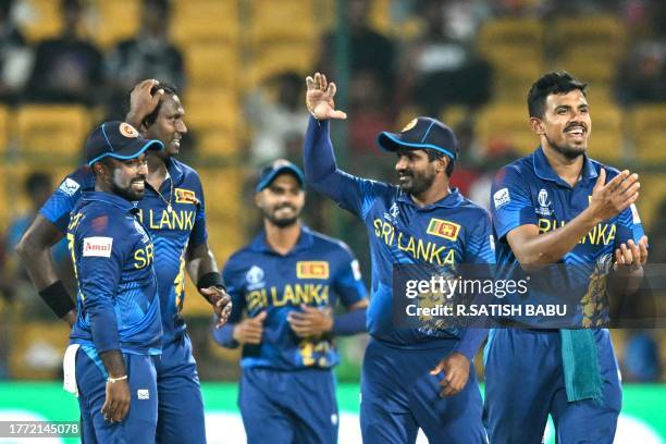 Sri Lanka's Angelo Mathews celebrates with teammates after taking the wicket of New Zealand's Mark Chapman during the 2023 ICC Men's Cricket World...