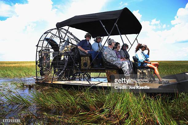 Sen. Bill Nelson rides in an airboat driven by Florida Fish and Wildlife Conservation commissioner Ron Bergeron as he and other officials tour a...