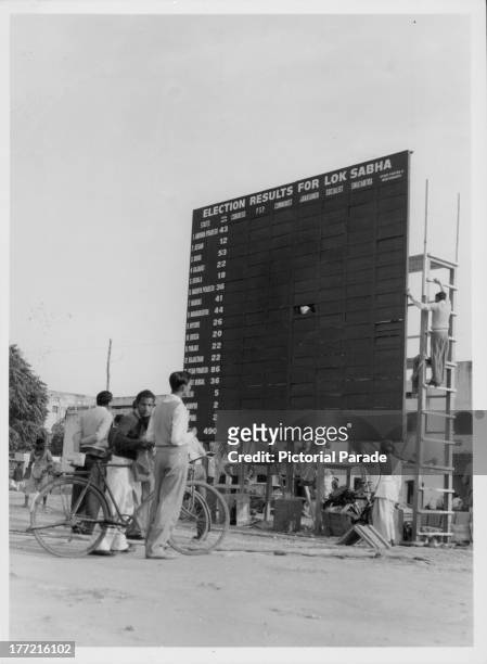 An election news board, Parliament Street, Connaught Place, New Delhi, India, 1962.