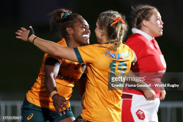 Ivania Wong of Australia celebrates with Georgina Friedrichs of Australia after scoring a try during the WXV1 match between Australia Wallaroos and...