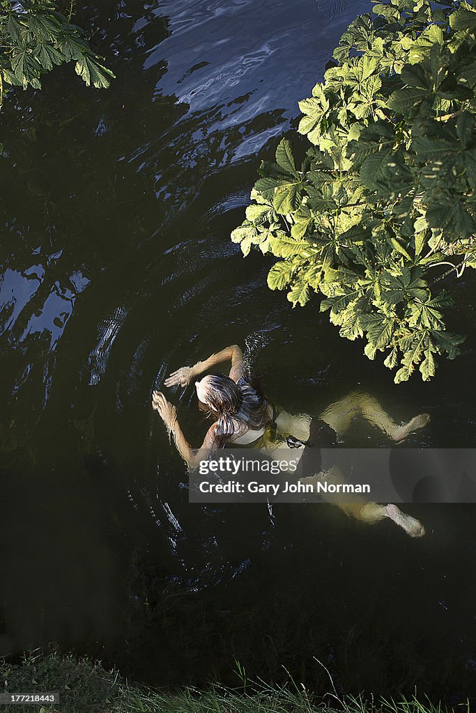 Young woman swimming in river
