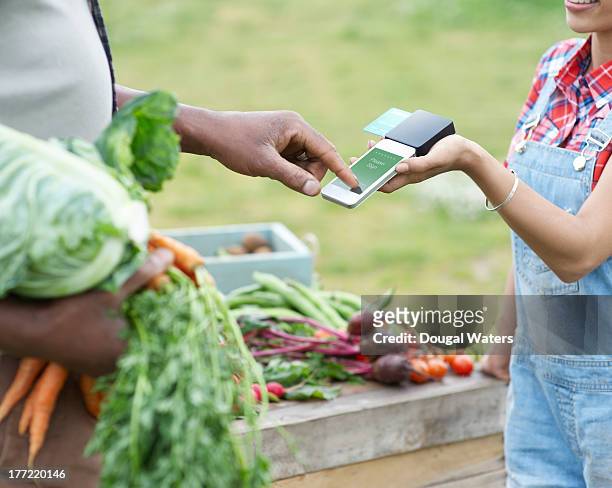 Man paying for vegetables.