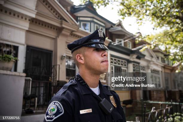 Officer Adam Fulmore, of the Camden County Police Department, goes on a foot patrol on August 22, 2013 in the Parkside neighborhood of Camden, New...