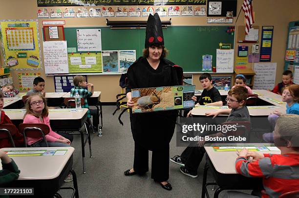Deirdre Arvidson, Public Health Nurse with the Barnstable County Dept. Of Health & Environment, dressed in a giant tick costume, talks with third...