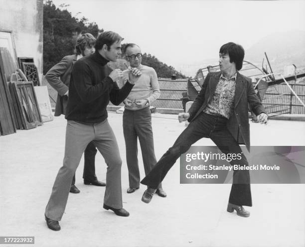 Actors Bruce Lee and John Saxon, with producer Raymond Chow, on the set of the movie 'Enter the Dragon', 1973.