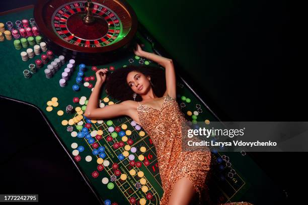 top photo of wealthy millionaire chic girl lying poker table enjoy fortunate winning on private club party - roleta, jogos - fotografias e filmes do acervo