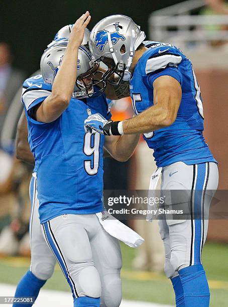 Tony Scheffler of the Detroit Lions celebrates a second quarter touchdown with Matthew Stafford while playing the New England Patriots during a pre...