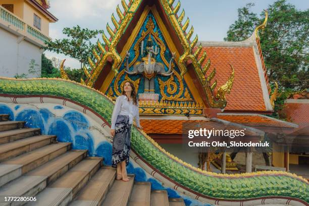 cheerful woman exploring in big buddha temple in koh samui - giant buddha stock pictures, royalty-free photos & images