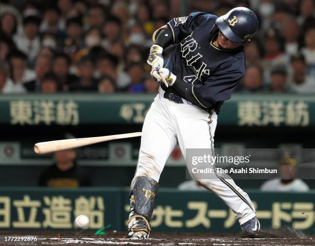 Tomoya Mori of the Orix Buffaloes hits a single while breaking his bat in the 7th inning against Hanshin Tigers during the Japan Series Game Four at...