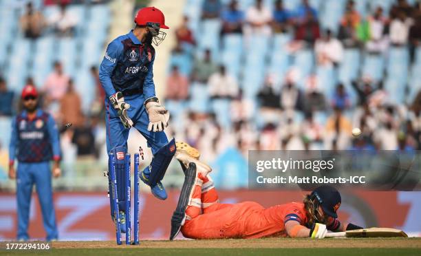 Max O'Dowd of Netherlands is run out as Ikram Alikhil of Afghanistan removes the bails during the ICC Men's Cricket World Cup India 2023 between...