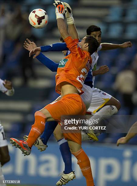Costa Rica's Herediano's goalkeeper Daniel Cambronero vies for the ball with Cruz Azul's forward Gerardo Amione during their Concacaf Champions...