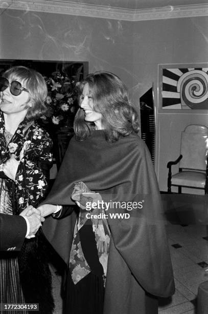 Shirley MacLaine and Kathleen Tynan attend a party at the Sassoon residence in Los Angeles, California, on May 27, 1978.
