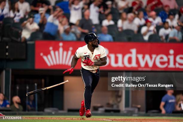 Adolis Garcia of the Texas Rangers flips his bat after hitting a home run during a game against the Minnesota Twins at Globe Life Field on September...