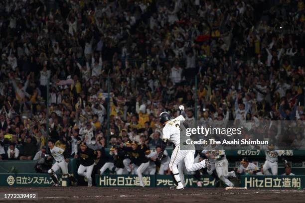 Yusuke Oyama of the Hanshin Tigers celebrates hitting a game-ending single in the 9th inning against Orix Buffaloes during the Japan Series Game Four...