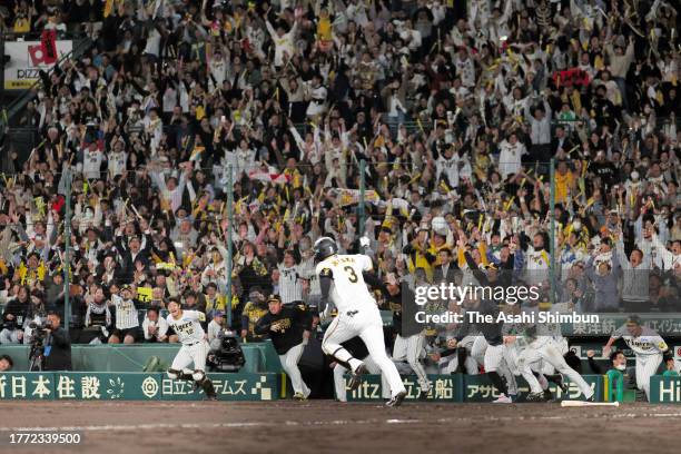 Yusuke Oyama of the Hanshin Tigers celebrates hitting a game-ending single in the 9th inning against Orix Buffaloes during the Japan Series Game Four...