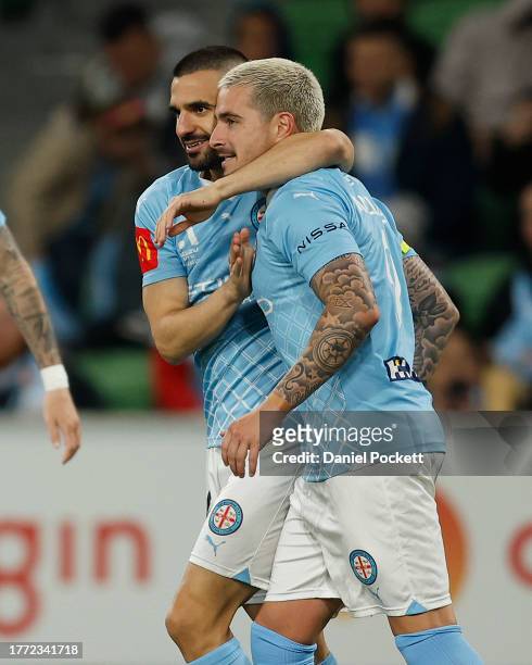 Jamie Maclaren of Melbourne City celebrates with Aziz Behich of Melbourne City after scoring a goal during the A-League Men round three match between...