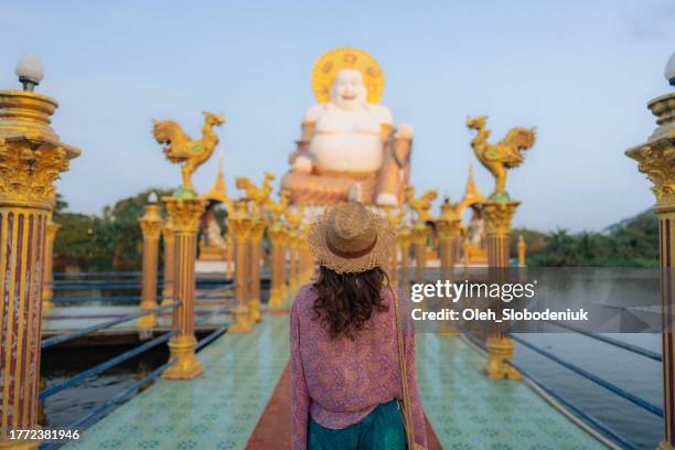 woman in straw hat in thai temple on koh samui - ko samui stock pictures, royalty-free photos & images