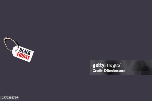 white tag with a string on a black background with letters that say: 'black friday', on the left side, with red and black letters. concept of black friday, offers, promotion, cheap prices, sales and consumerism. - f��retag bildbanksfoton och bilder