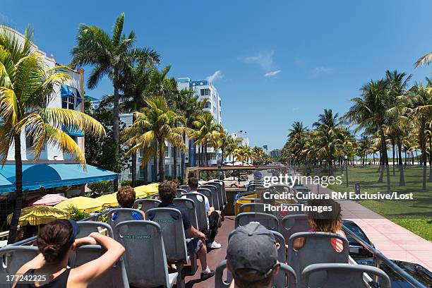 tourists on a bus in miami beach, florida, usa - dubbeldekker bus stockfoto's en -beelden