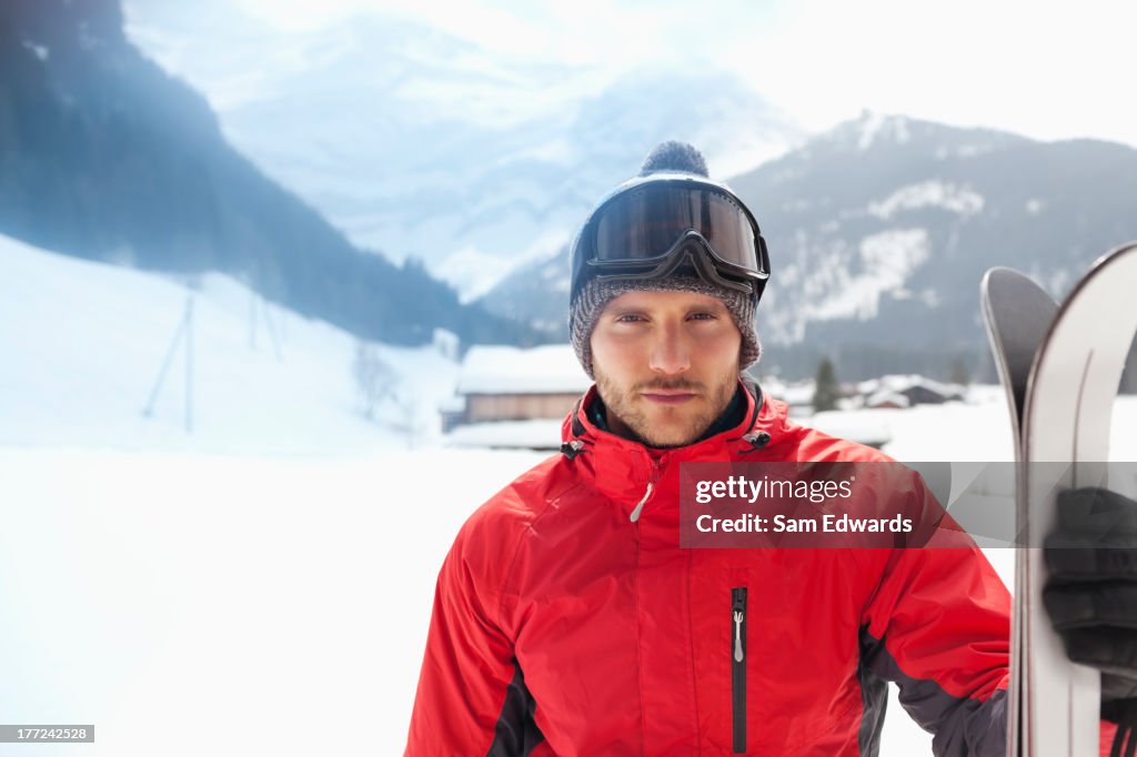 Porträt von zuversichtlich Mann mit Skifahren im snowy field