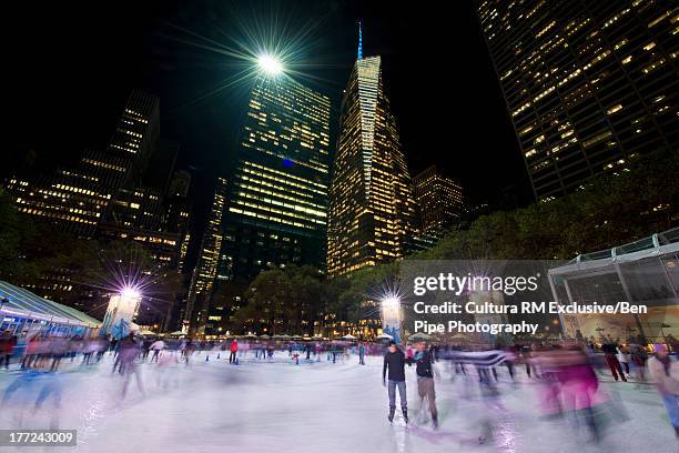 ice skating at bryant park, manhattan, new york city, usa - ice rink stock pictures, royalty-free photos & images