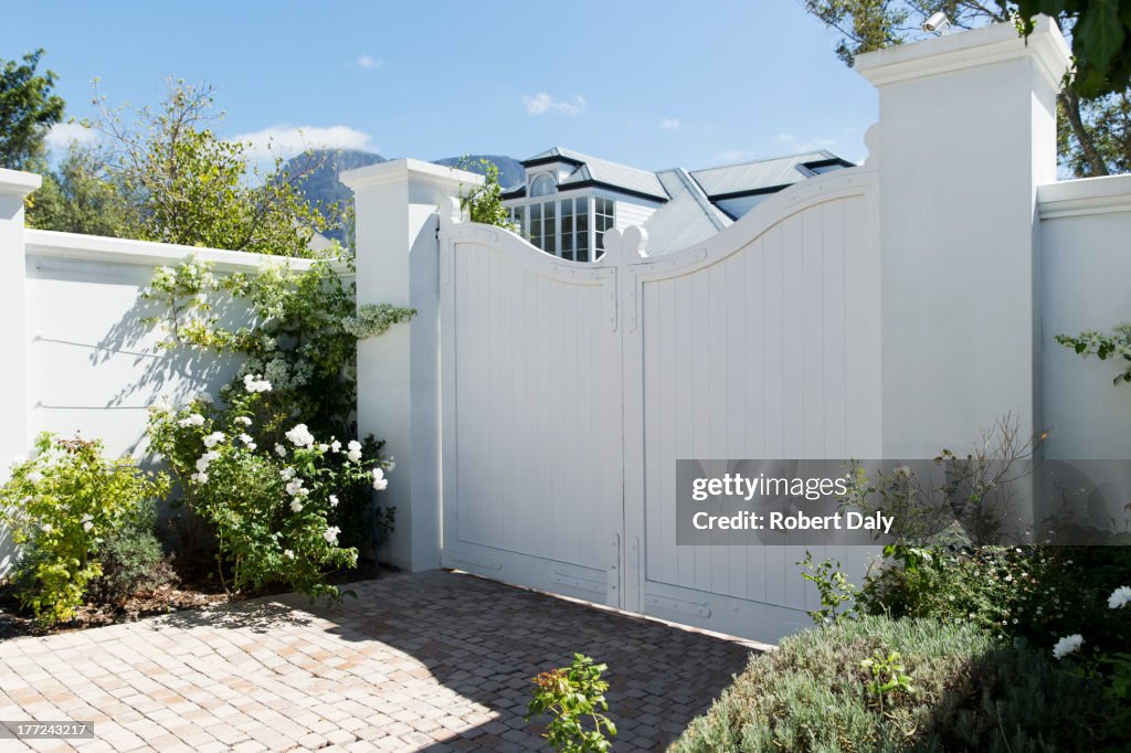 White gate outside luxury house