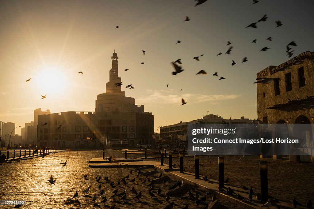 Sunrise over minaret of Qatar Mosque/ Islamic Cultural Center (Fanar), Doha, Qatar