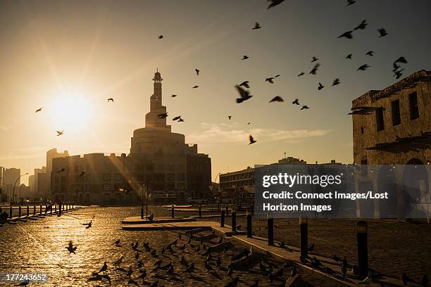 sunrise over minaret of qatar mosque/ islamic cultural center (fanar), doha, qatar - qatar mosque stock pictures, royalty-free photos & images