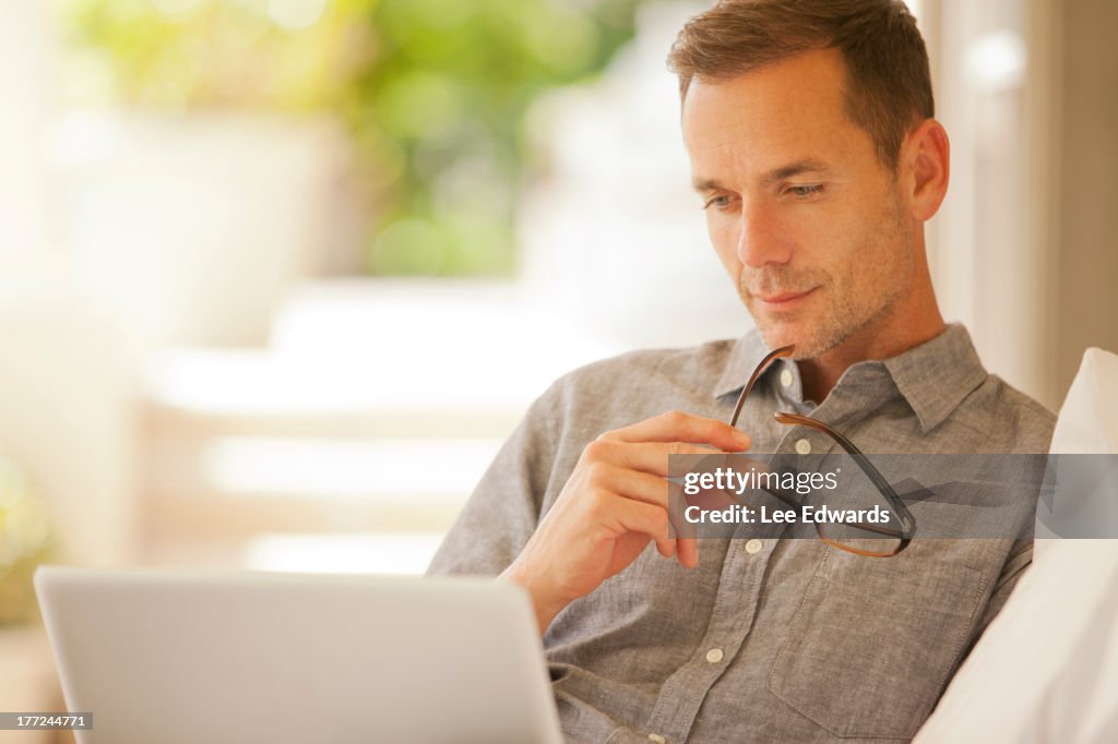 Pensive man using laptop