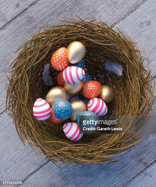 stockillustraties, clipart, cartoons en iconen met vibrant patterned easter eggs in a nest on a wooden table looking down 3d render - easter table