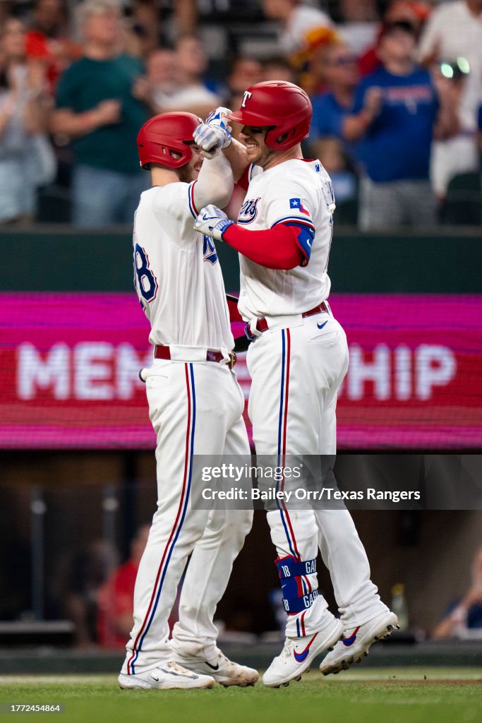 Texas Ranger Heim Mitch Garver high fives Jonah Heim of the Texas Rangers after hitting ...