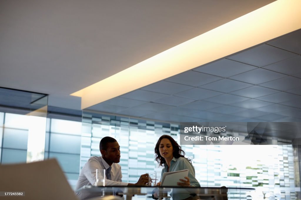 Businessman and businesswoman discussing paperwork