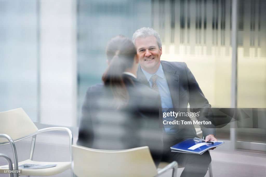 Smiling businessman talking to businesswoman