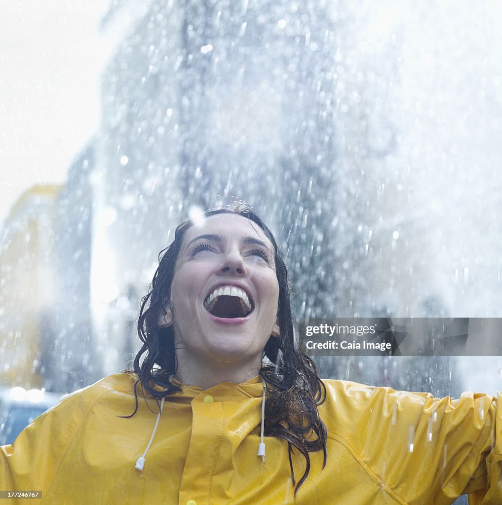 Enthusiastic woman standing in rain