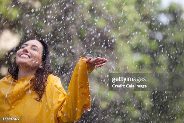 happy woman standing with arms outstretched in rain - head back stock pictures, royalty-free photos & images