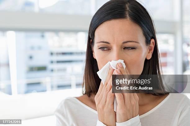 close-up of a woman sneezing - closeup of a hispanic woman sneezing foto e immagini stock