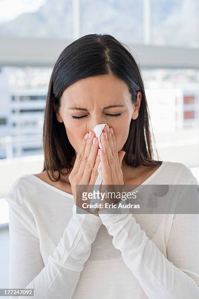 close-up of a woman sneezing - closeup of a hispanic woman sneezing stock pictures, royalty-free photos & images