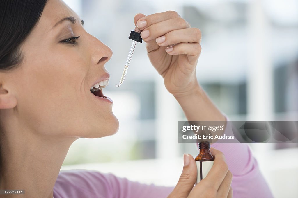 Close-up of a woman taking homeopathic medicine