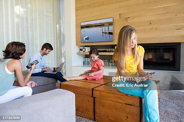 family using electronics gadgets - stiefmutter stock-fotos und bilder