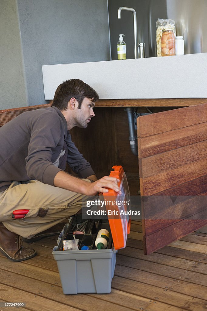 Man repairing a kitchen sink