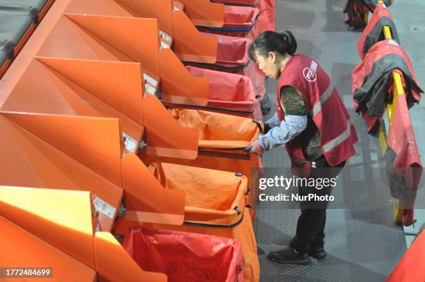 Workers at an e-commerce logistics industrial park sorts parcels of express Double 11 shopping carnival on an express assembly line in Lianyungang,...