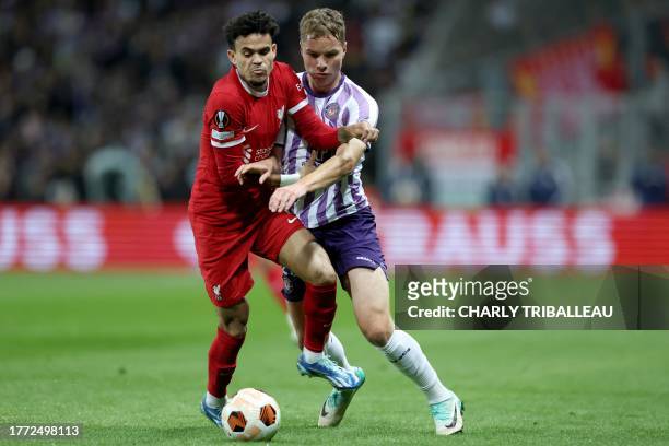 Liverpool's Colombian midfielder Luis Diaz and Toulouse's German midfielder Niklas Schmidt fight for the ball during the UEFA Europa League Group E...