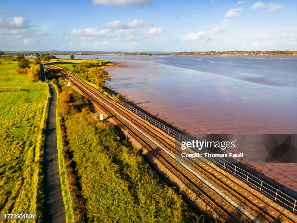 waterfront railway track along river exe - thomas stock pictures, royalty-free photos & images