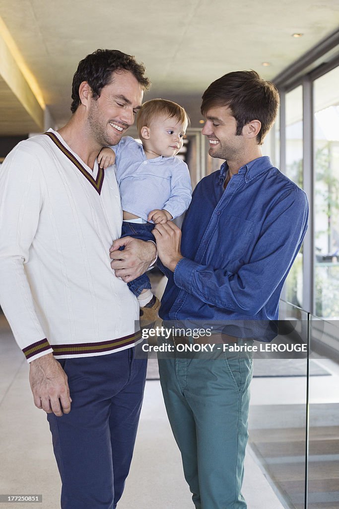 Parents smiling with their son at home