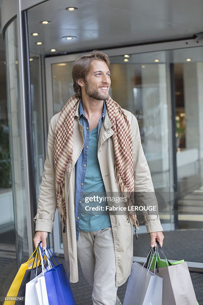 Man carrying shopping bags and smiling